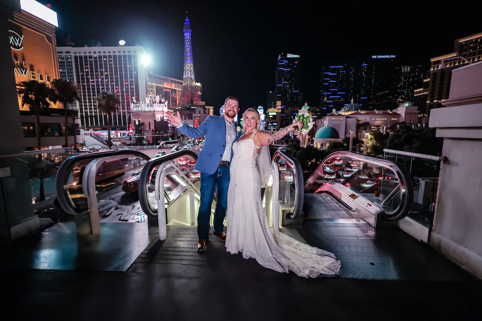 Newlyweds celebrating on the Las Vegas Strip at night with the Eiffel Tower and city skyline in the background