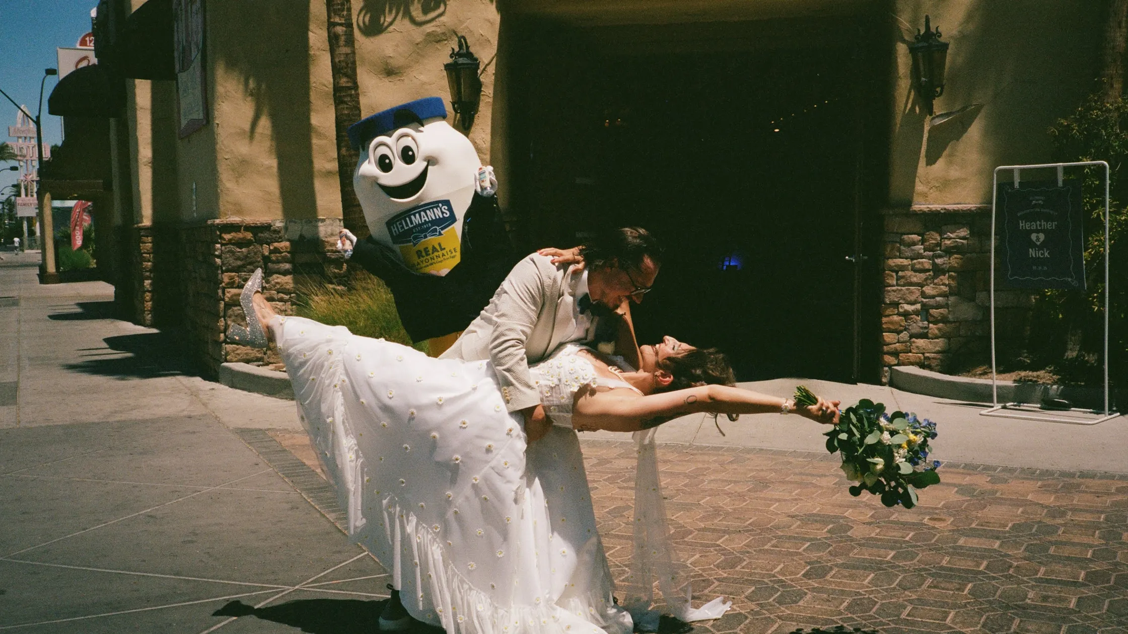 Bride and groom dip kissing with Hellmann