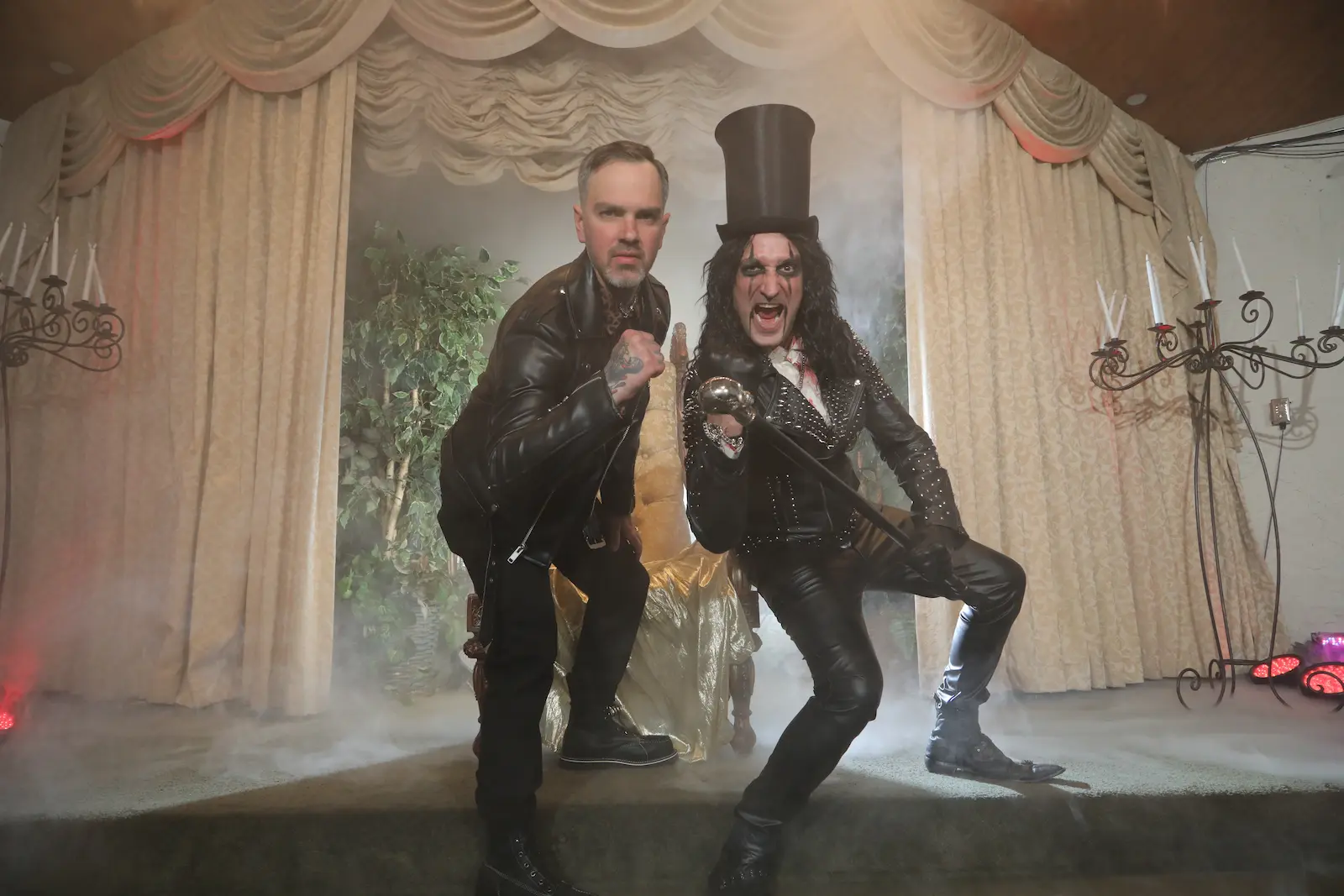Groom posing with Alice Cooper impersonator on stage with fog at a Las Vegas wedding chapel
