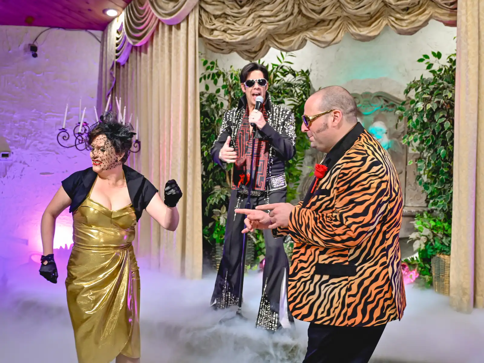 Las Vegas Elvis wedding couple dancing in fun outfits while Elvis impersonator sings on chapel stage