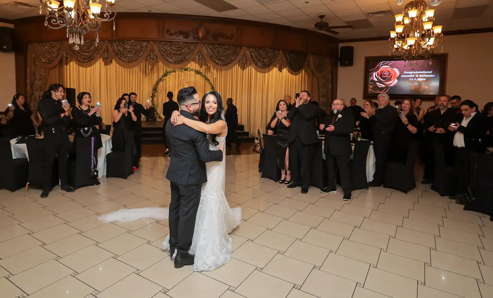 Bride and groom sharing first dance at Vegas Event Center wedding reception surrounded by cheering guests