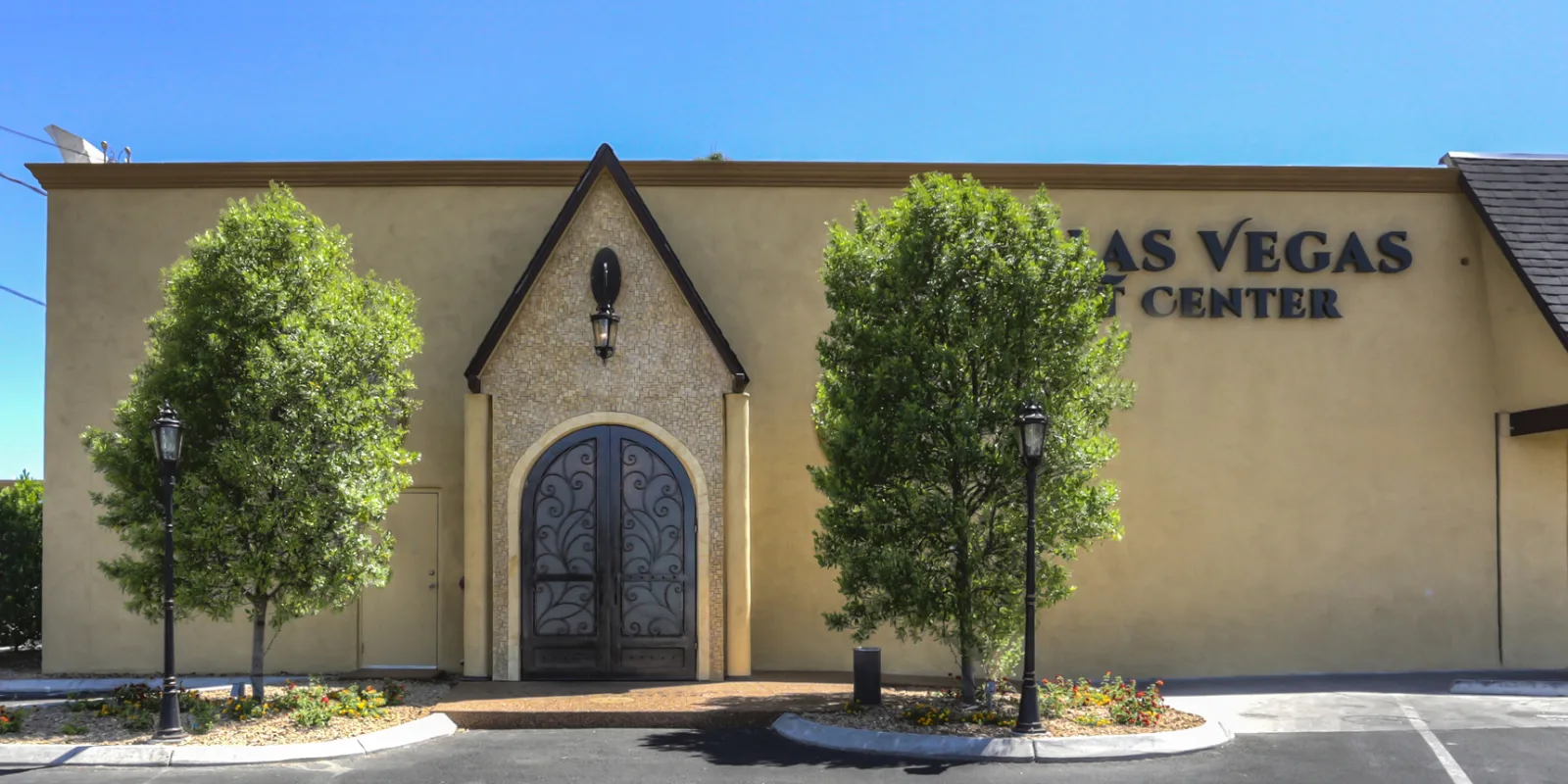 Vegas Event Center exterior entrance with ornate iron doors and landscaping in Las Vegas