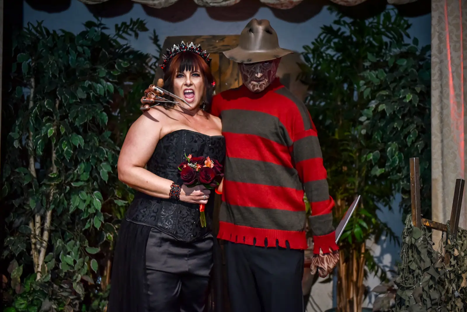 Gothic bride posing with Freddy Krueger and his razor-clawed glove at a Las Vegas horror wedding