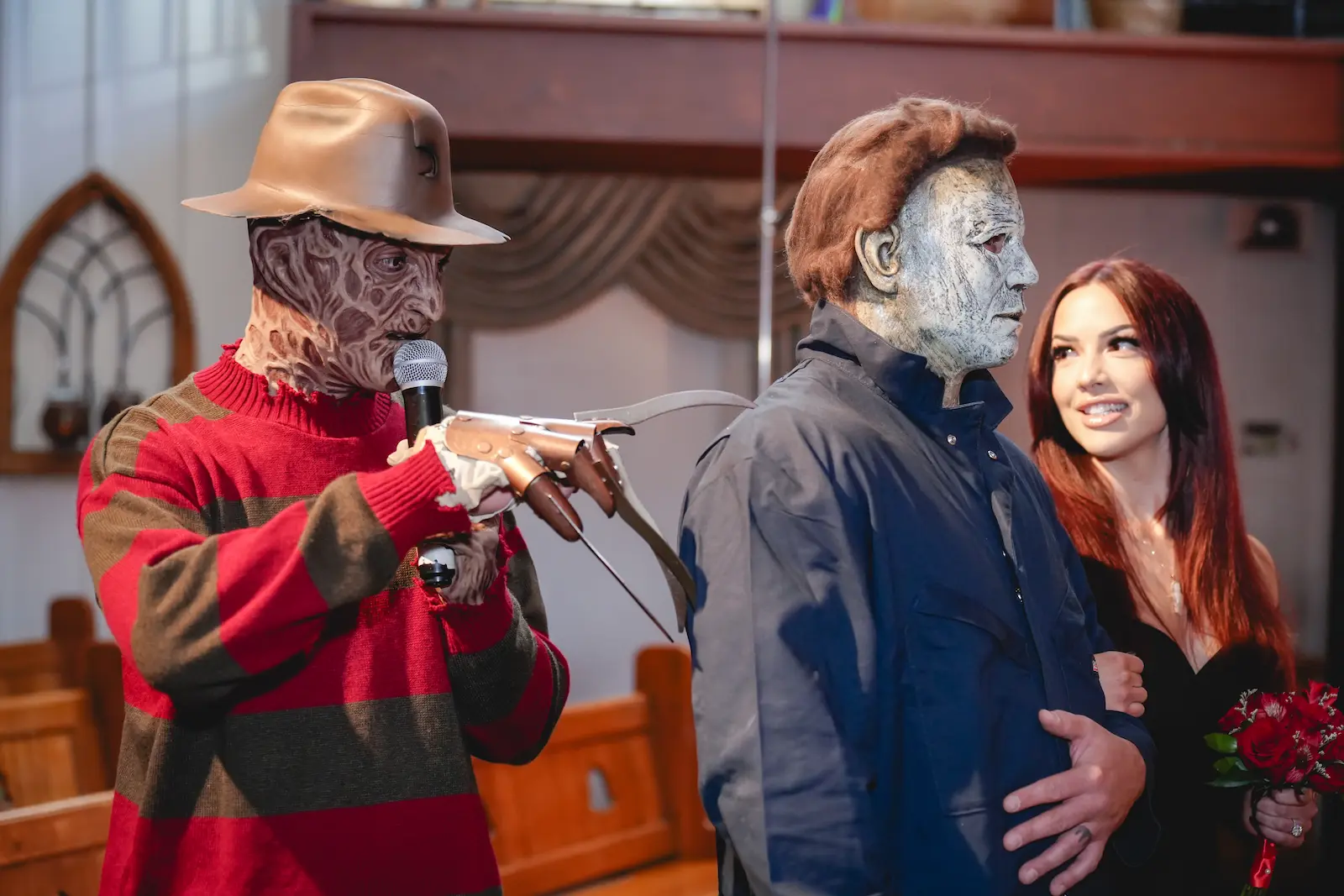 Freddy Krueger officiating a Las Vegas wedding chapel ceremony alongside Michael Myers and a smiling bride with red roses