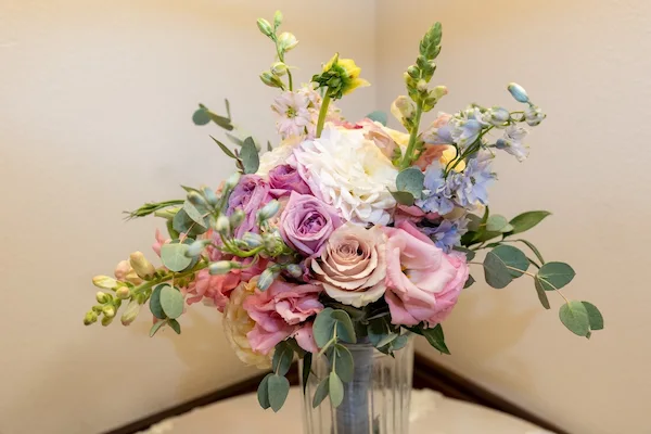 Romantic pastel bouquet with pink roses, lavender blooms, and eucalyptus