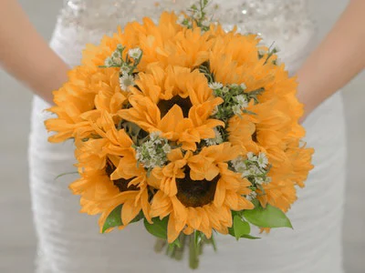 Bright round bouquet packed with golden sunflowers and wispy filler flowers