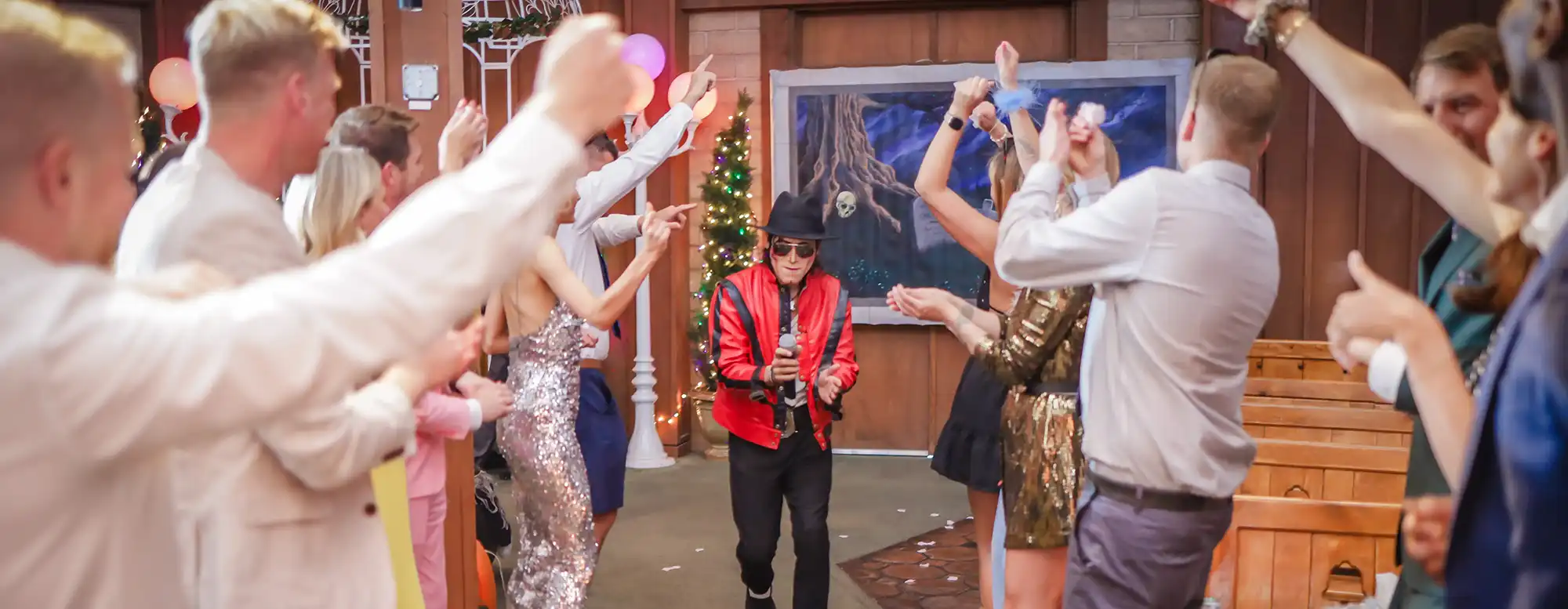 Michael Jackson impersonator in a red Thriller jacket performs at a Vegas wedding as guests dance