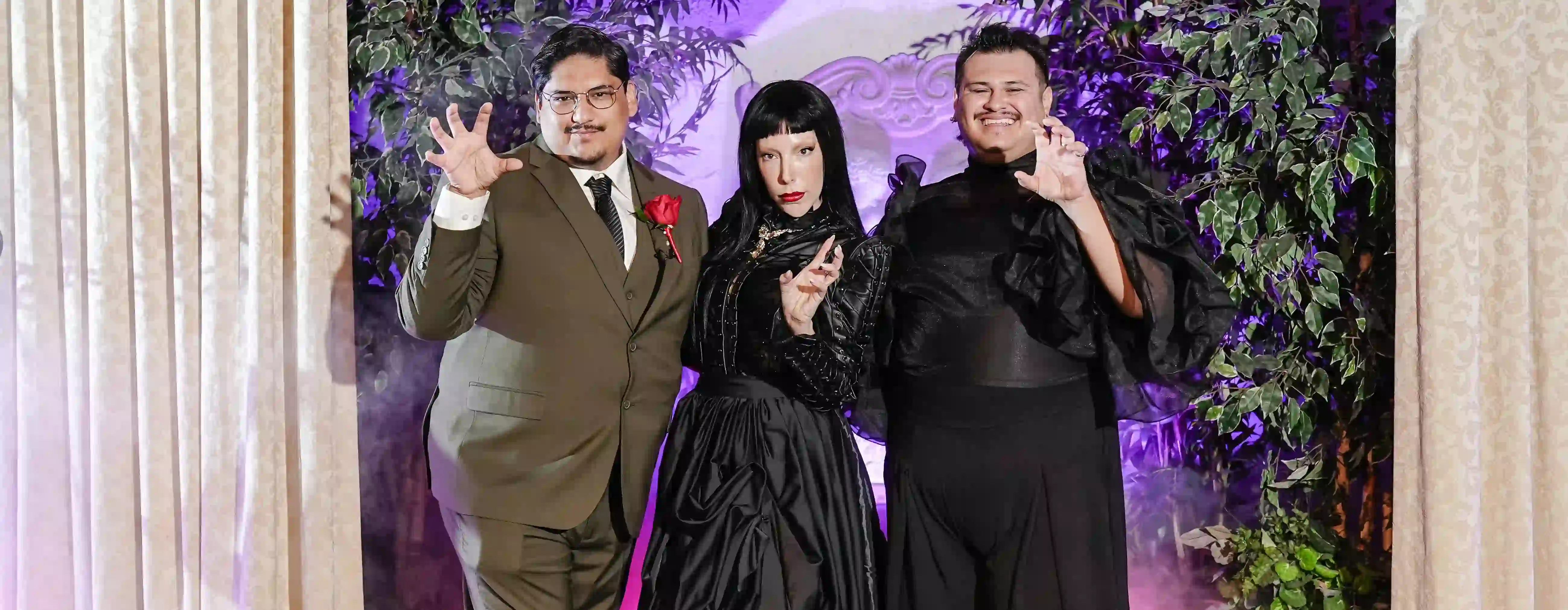 Lady Gaga entertainer poses with grooms at a gothic Vegas wedding