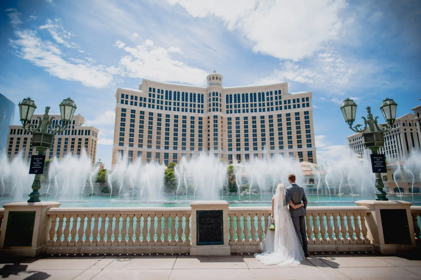 Bride and groom watching the Bellagio fountains on the Las Vegas Strip on their wedding day.