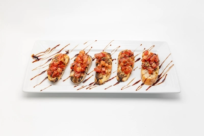 Tomato bruschetta on toasted bread with balsamic drizzle