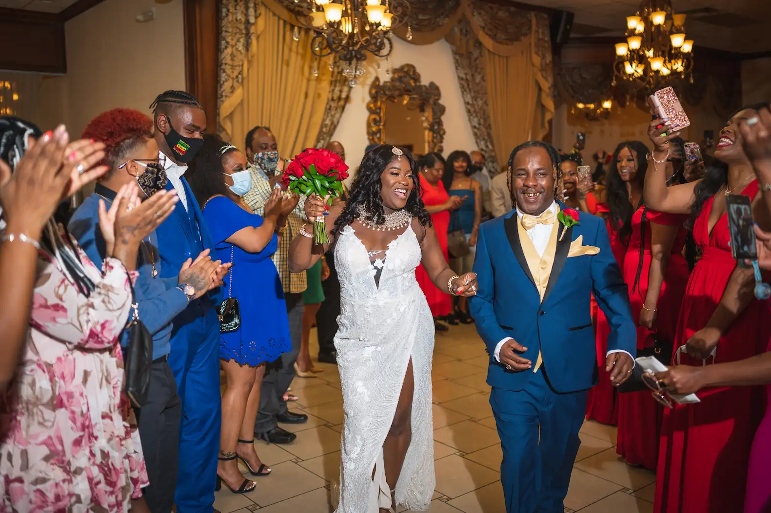 Newlywed couple making their grand entrance with guests cheering at a Las Vegas wedding reception