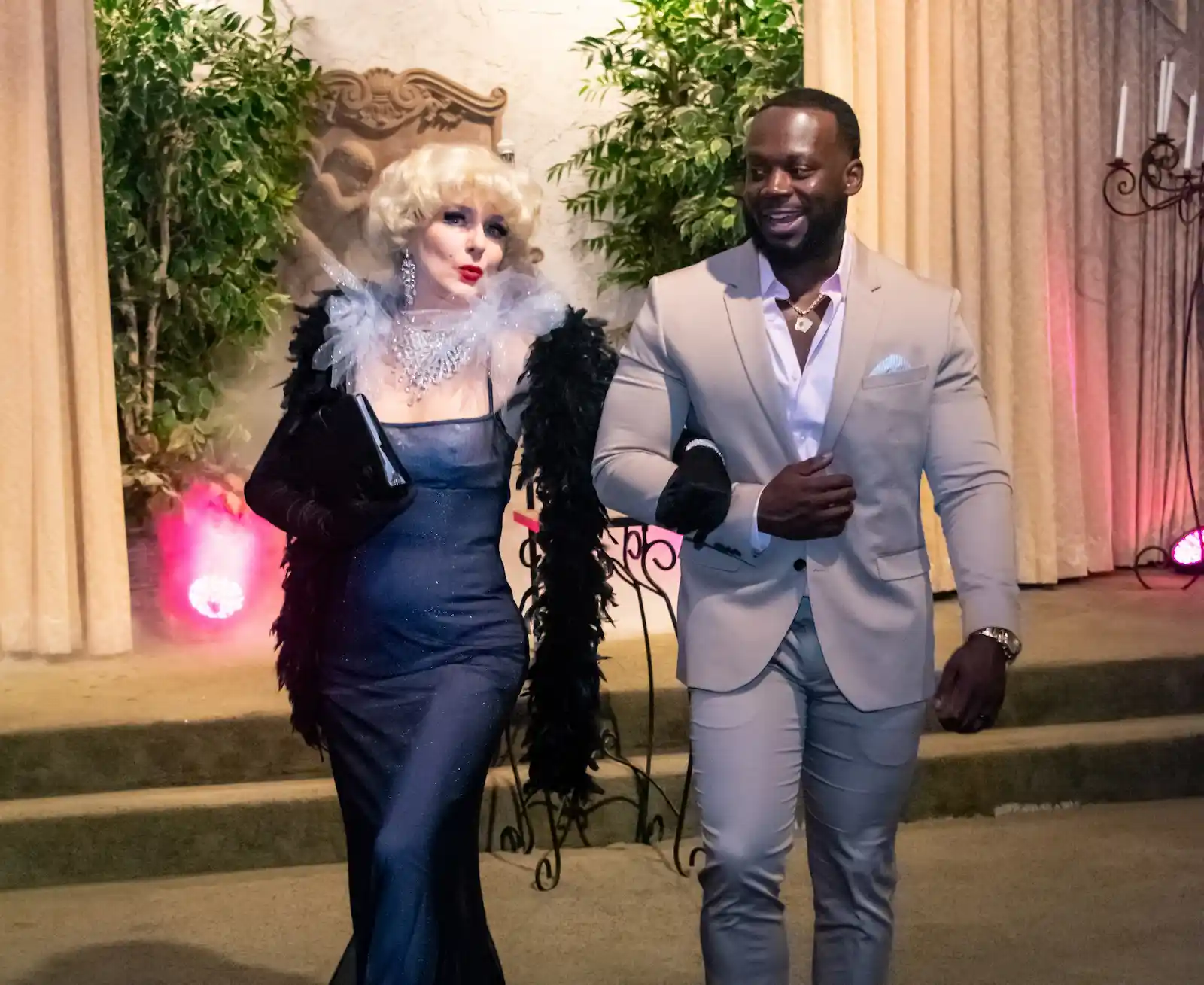 Marilyn Monroe impersonator in sparkly blue gown and feather boa escorting wedding guest at Viva Las Vegas wedding chapel