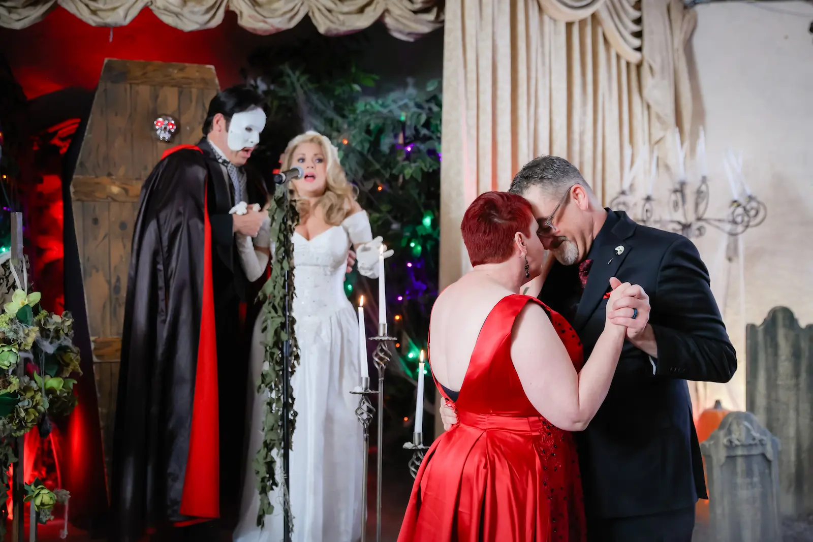 Wedding couple slow dancing while Phantom of the Opera characters sing at Halloween themed Las Vegas chapel
