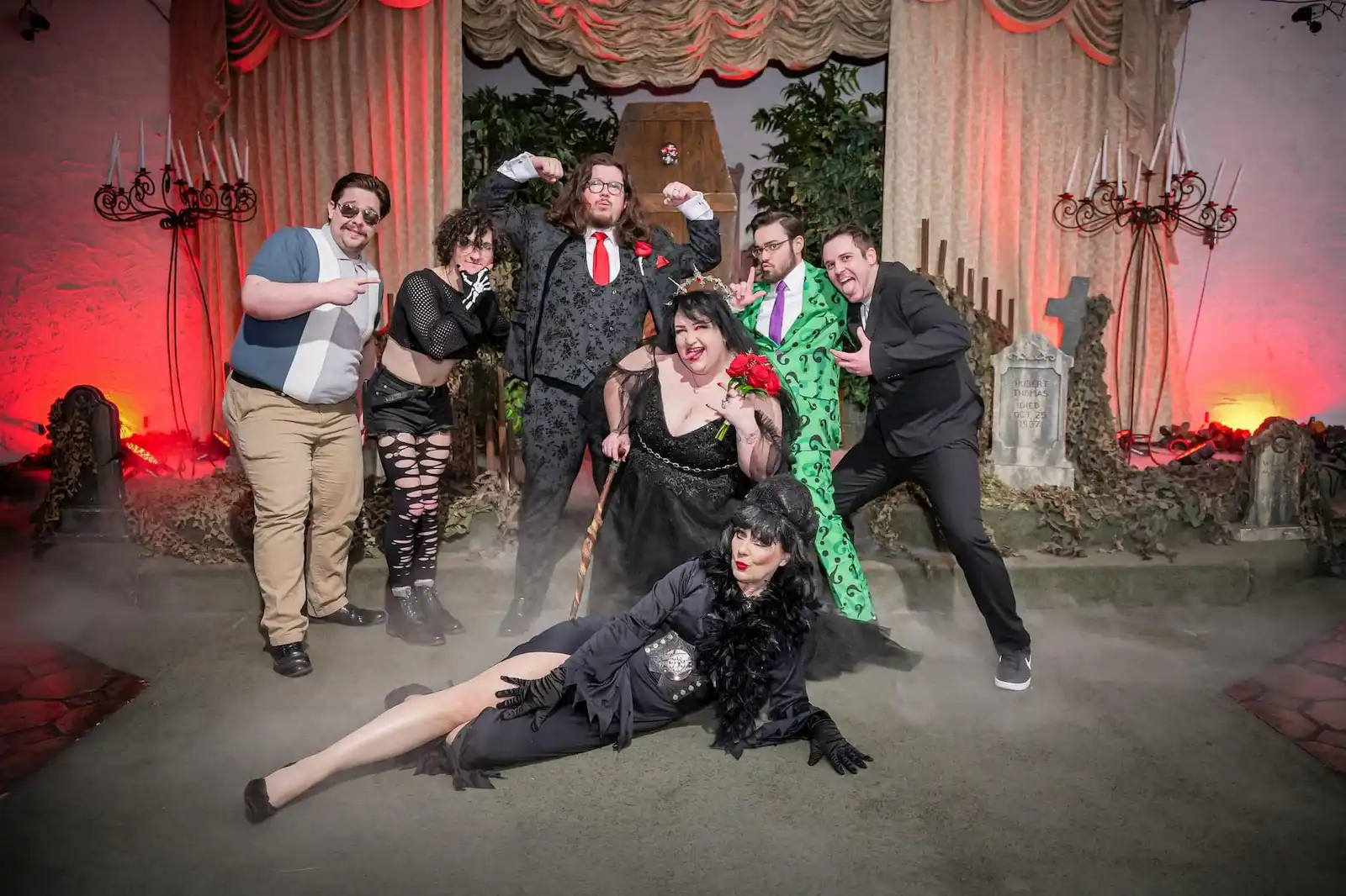 Wedding party in gothic Halloween costumes posing at a spooky Las Vegas wedding chapel with fog and gravestones