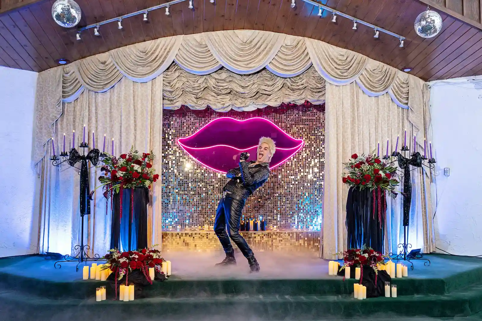 Billy Idol impersonator performing with dry ice fog during themed wedding ceremony at Viva Las Vegas Wedding Chapel