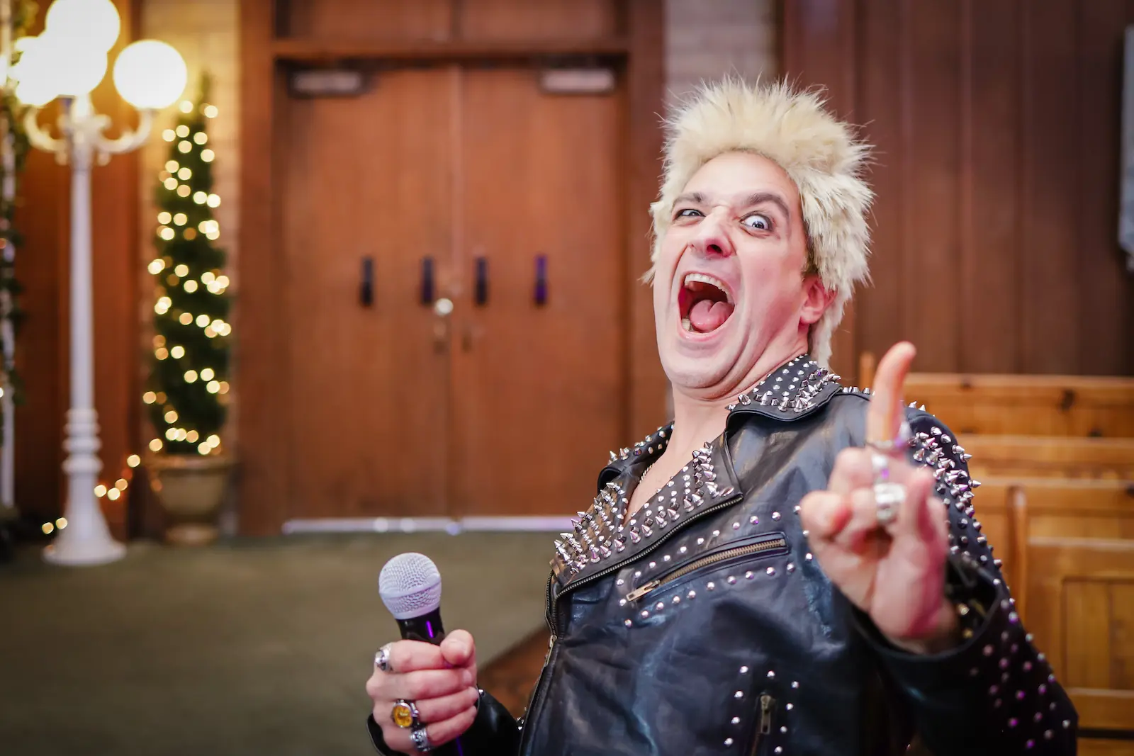 Billy Idol impersonator in spiked leather jacket performing at Las Vegas themed wedding chapel