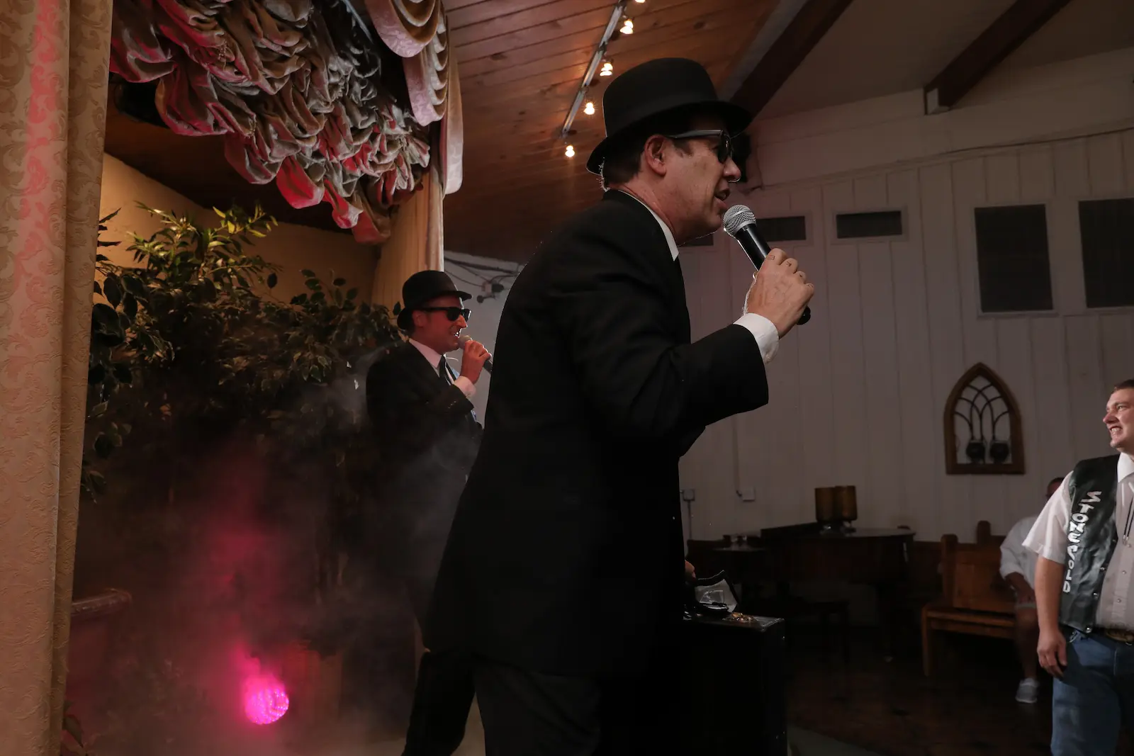 Blues Brothers impersonators performing microphone fog effects Las Vegas wedding chapel
