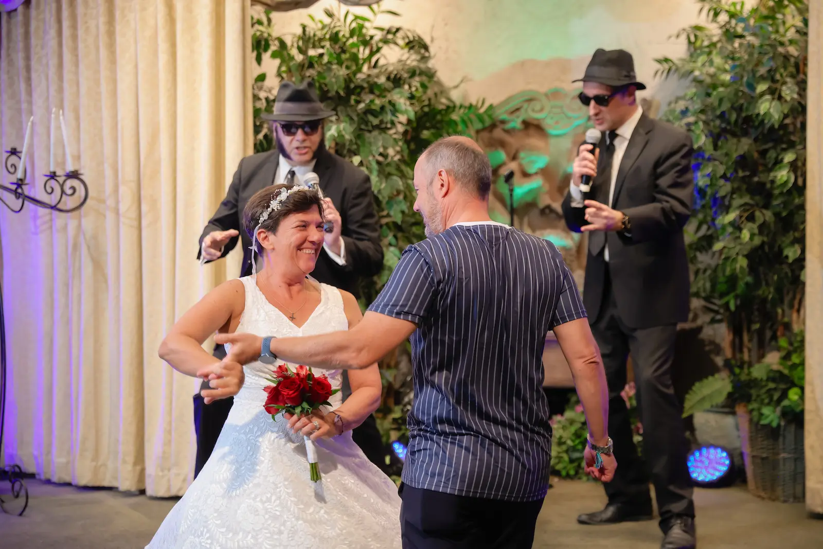 bride groom dancing Blues Brothers impersonators singing microphones Las Vegas wedding