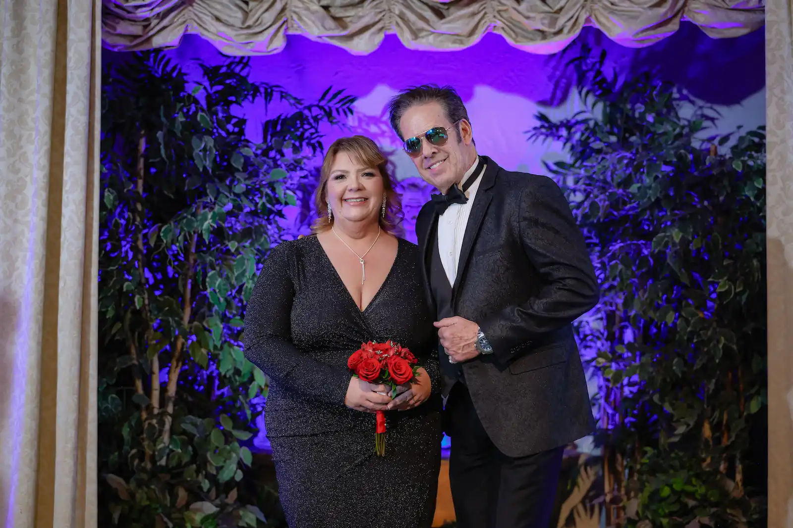 Bride in black sequin dress and James Bond impersonator pose together at James Bond themed Las Vegas wedding