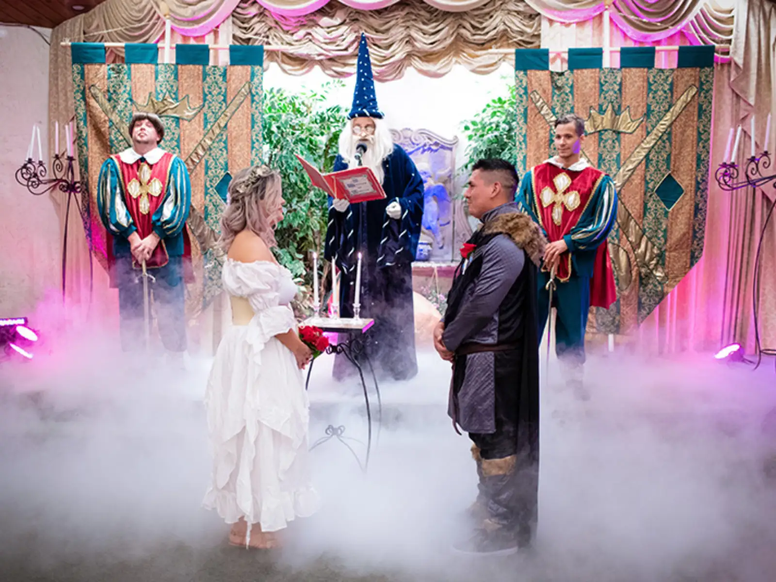 A couple getting married in a fantasy, Harry Potter-inspired wedding chapel in Las Vegas with a wizard officiant and knights.