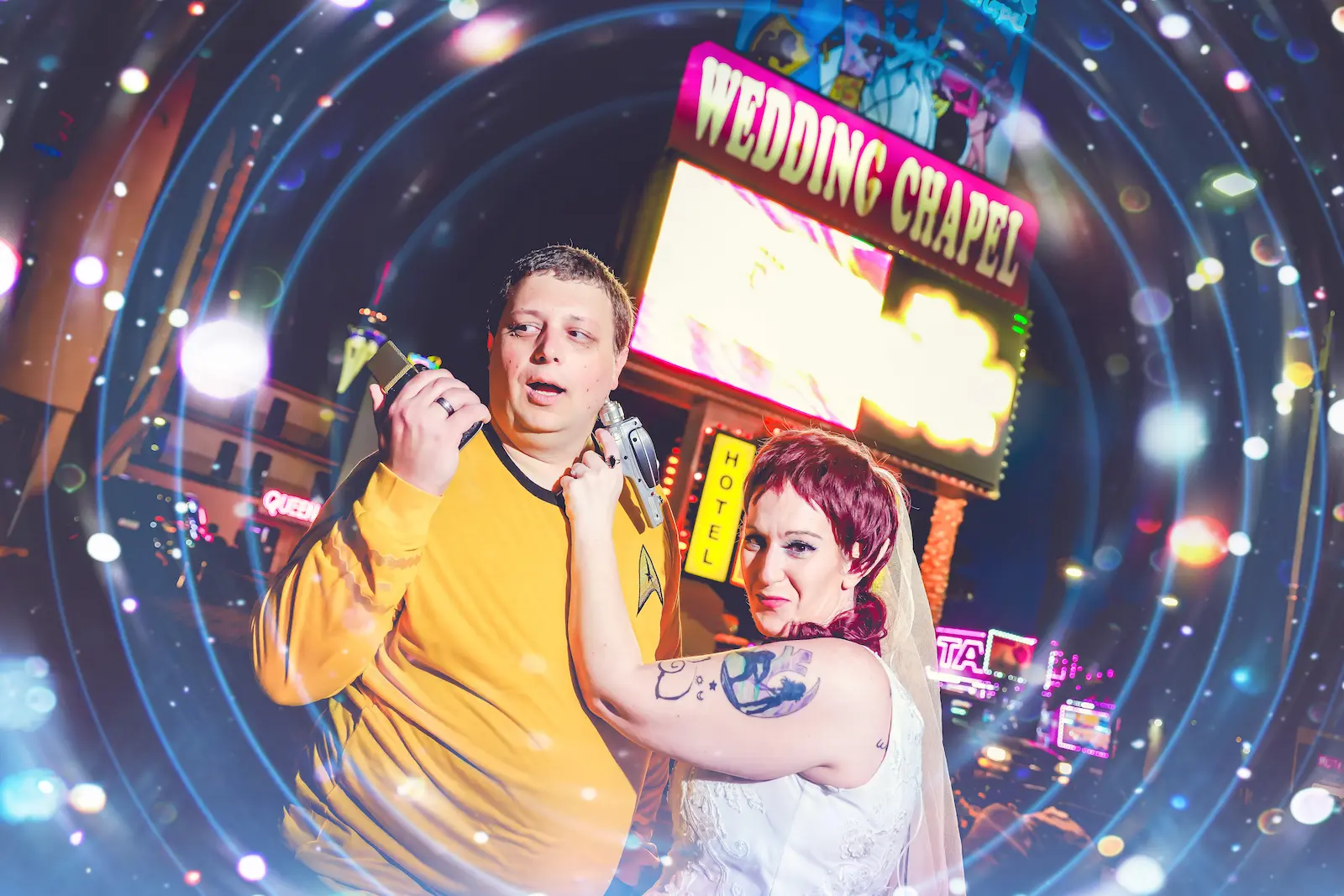 Star Trek-themed couple posing with toy phasers under a swirling galaxy effect in front of a Las Vegas wedding chapel sign.