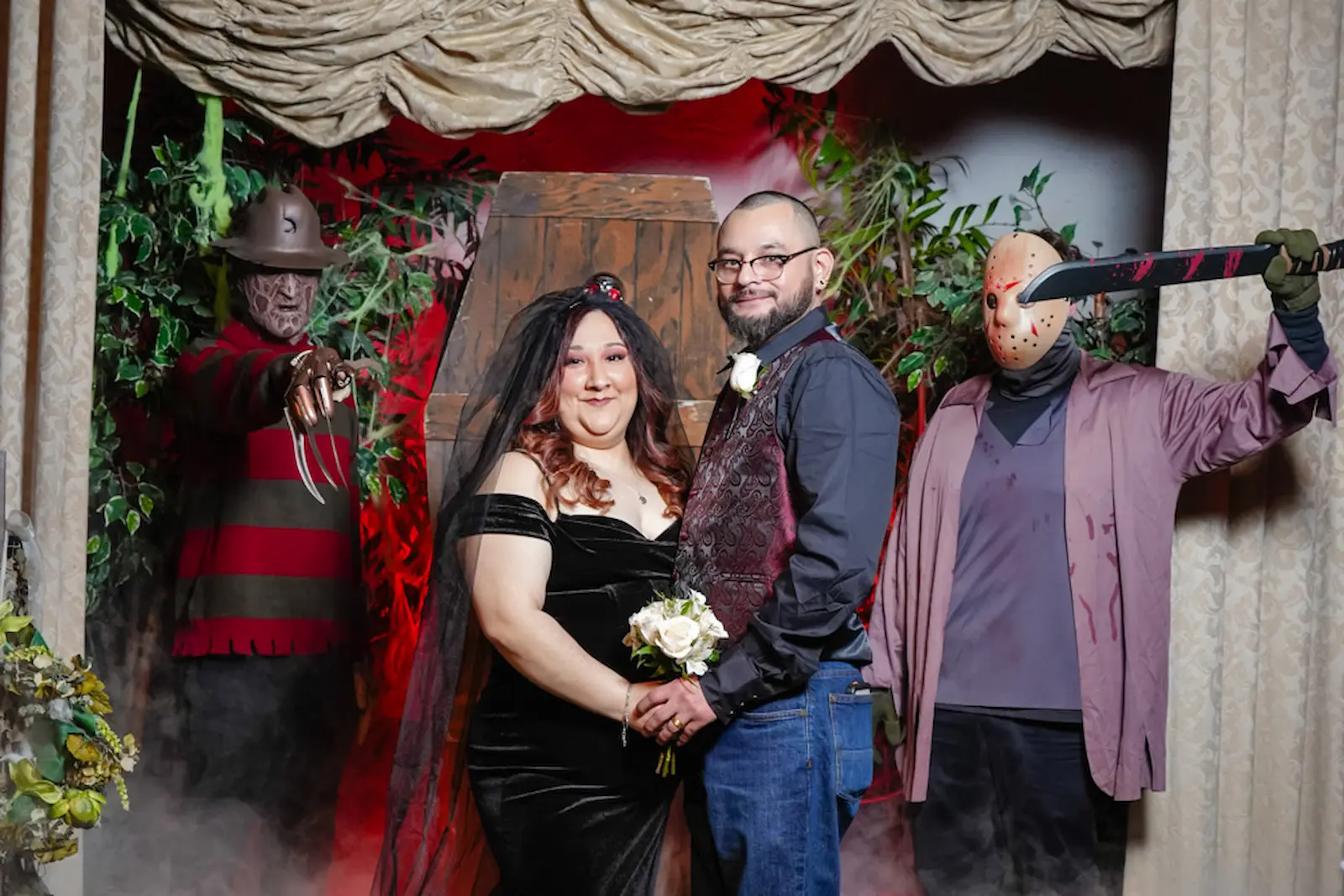 Newlyweds posing with Freddy Krueger and Jason Voorhees costumes at horror themed wedding at Viva Las Vegas Wedding Chapel