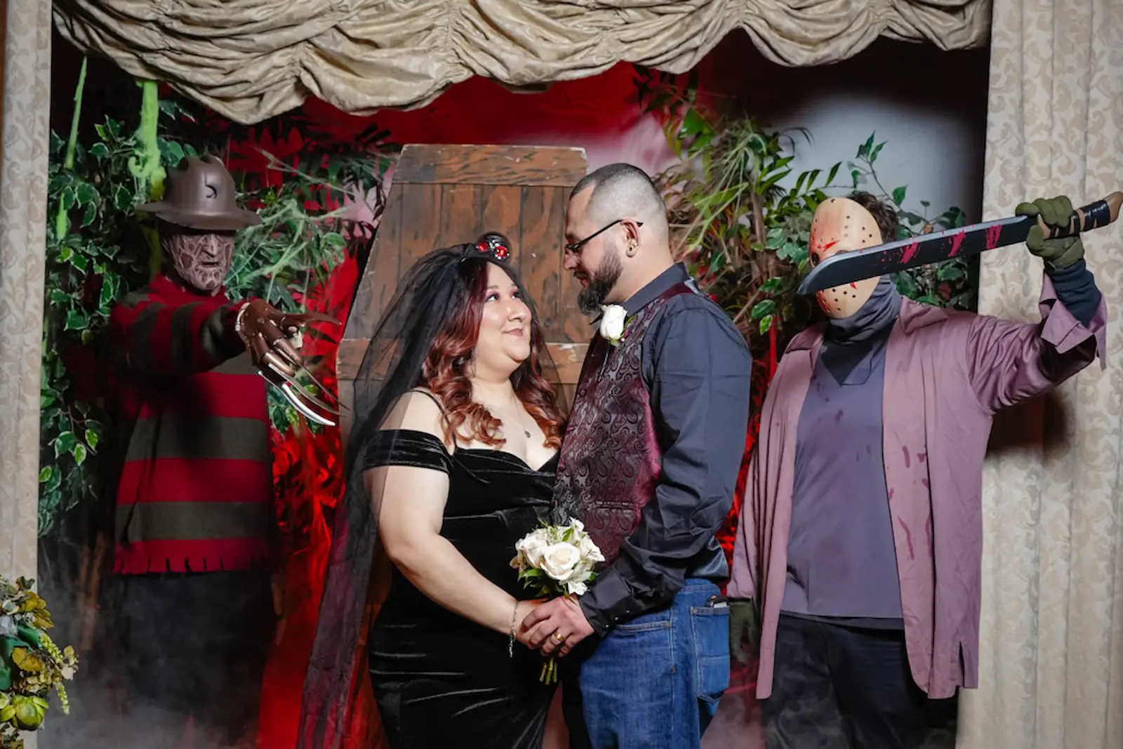 Couple gazing at each other surrounded by Freddy Krueger and Jason Voorhees at horror themed wedding at Viva Las Vegas