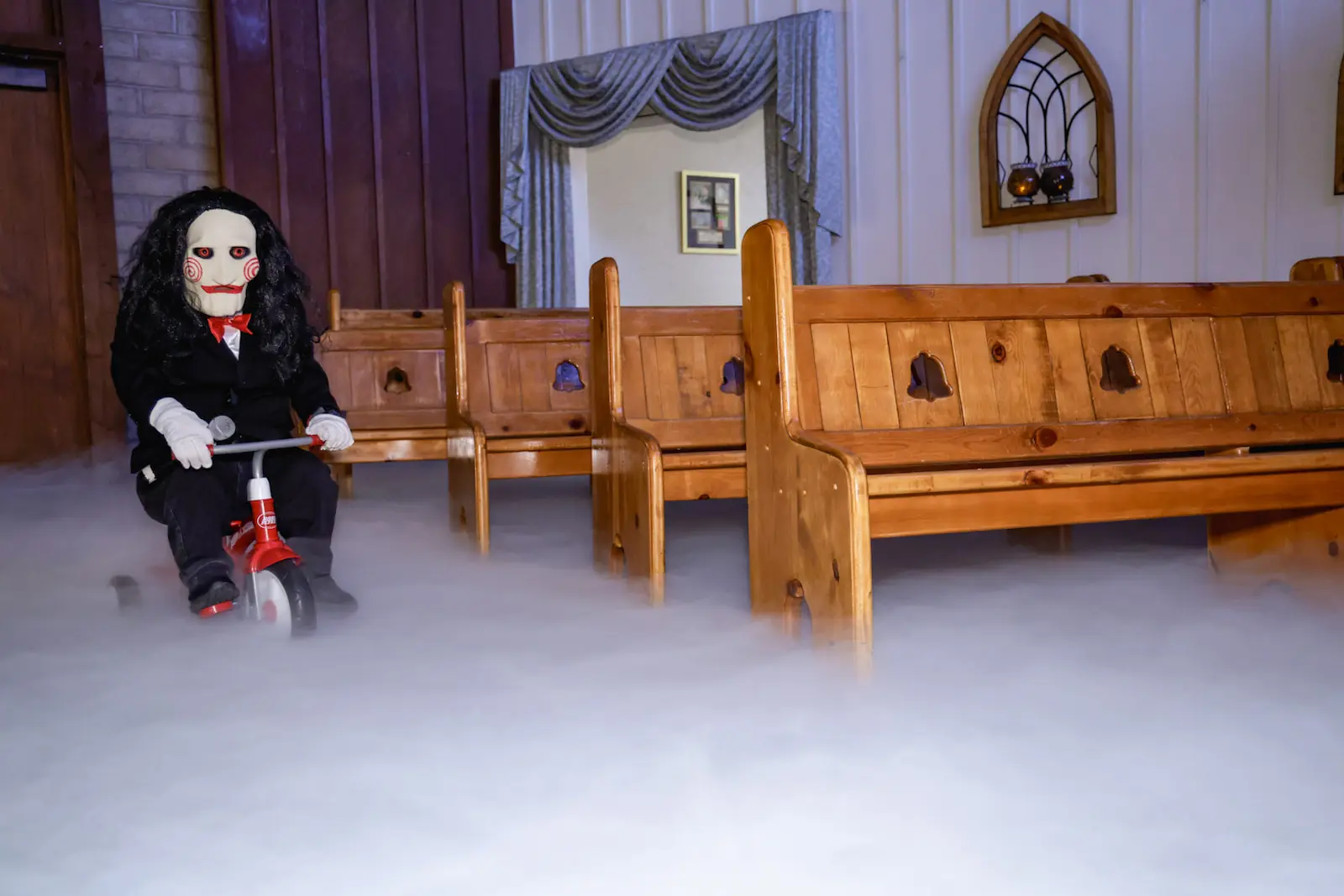 Saw Billy puppet on tricycle with dry ice fog in wedding chapel aisle at Viva Las Vegas