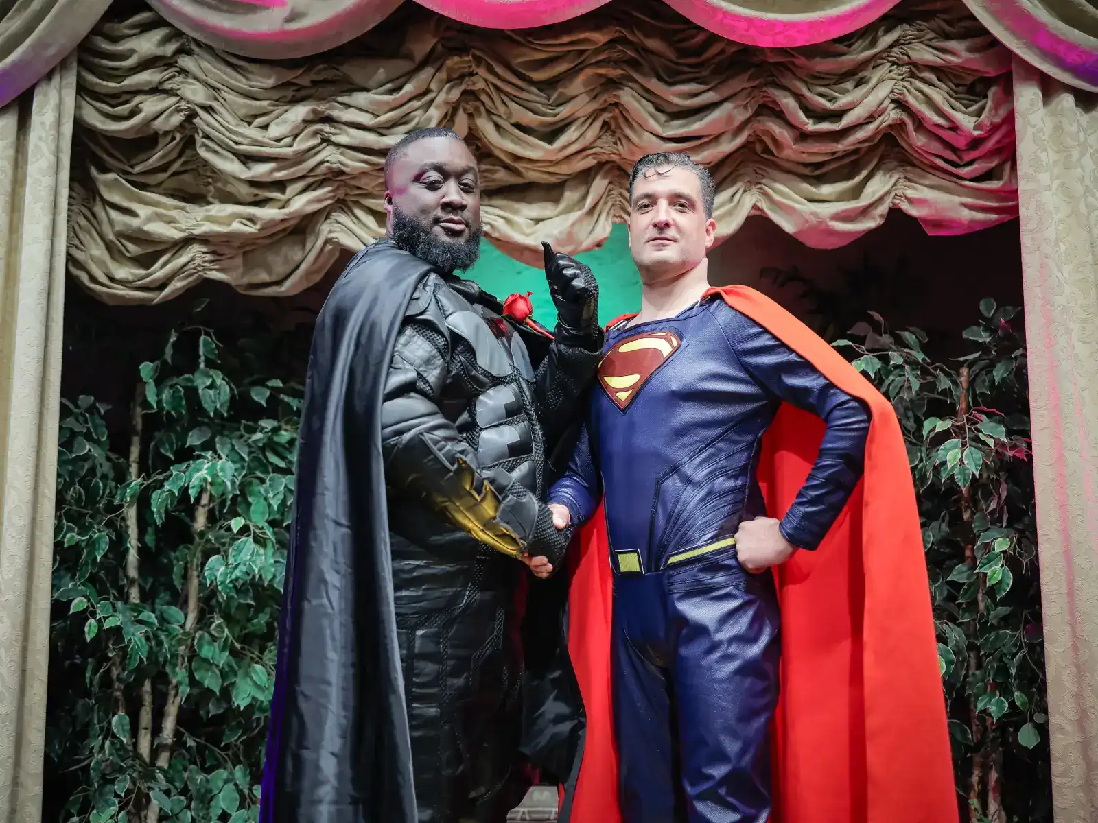 superhero wedding characters batman and superman shaking hands at las vegas themed ceremony