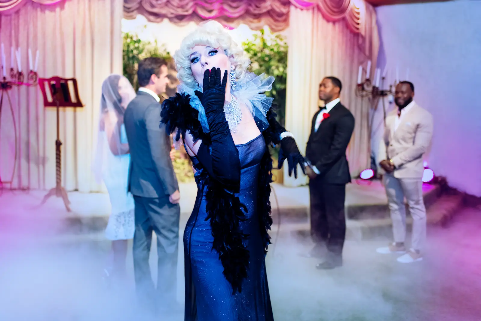 Marilyn Monroe impersonator black gown feather boa gloves blowing kiss Las Vegas wedding
