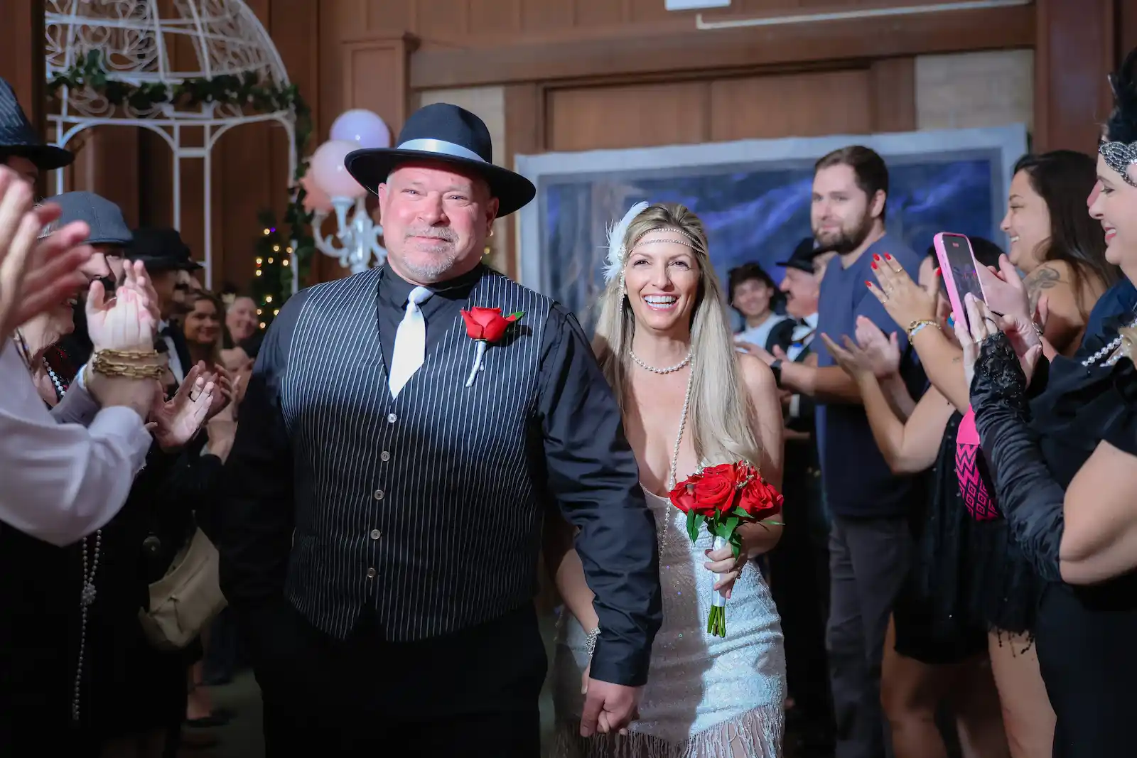 Gangster themed newlyweds walk down aisle through cheering guests at Las Vegas wedding chapel