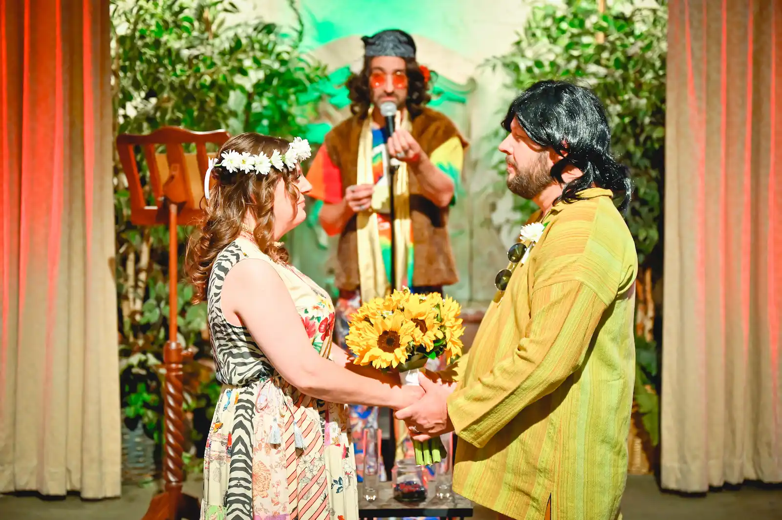 Bride with flower crown and sunflower bouquet exchanges vows with groom as hippie officiant performs at Las Vegas chapel