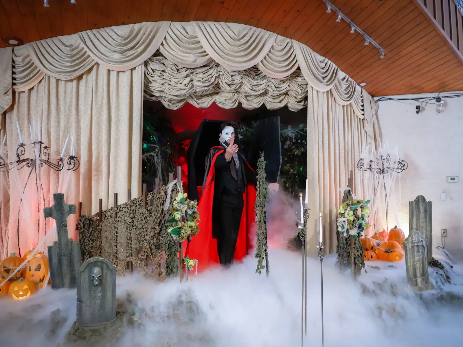 phantom impersonator entrance with fog and gothic halloween wedding stage