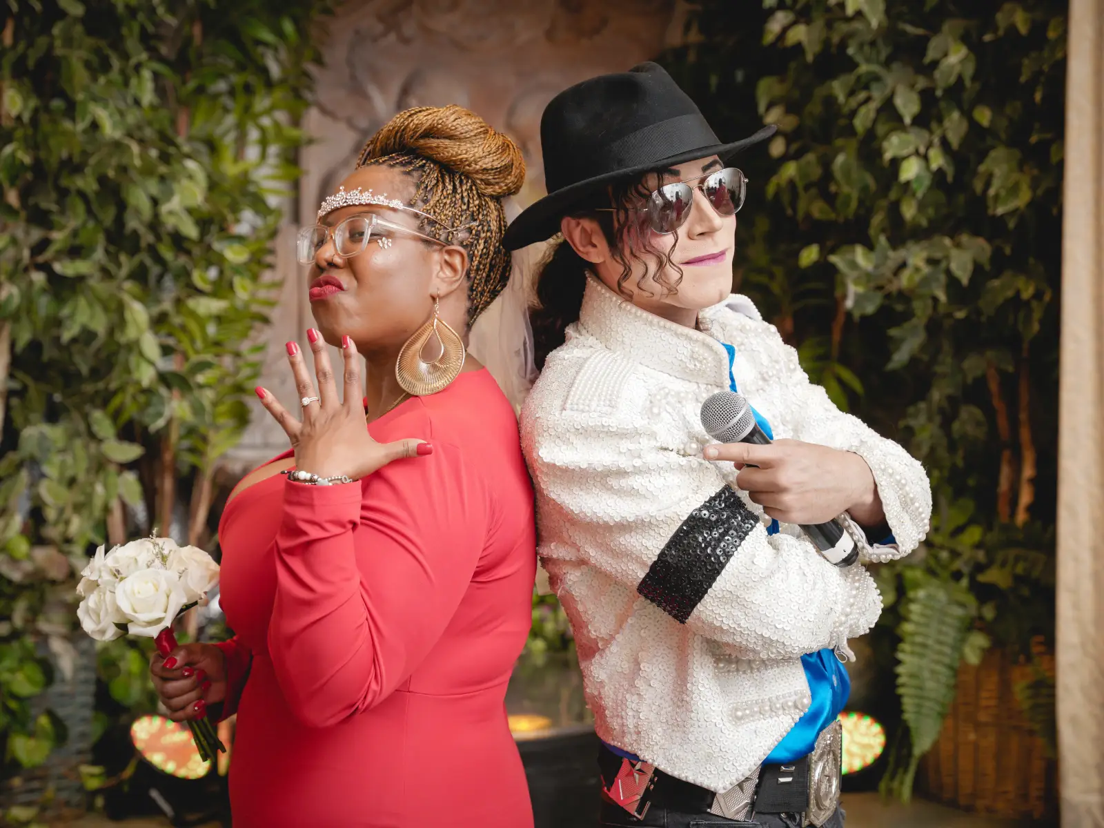 Bride shows off wedding ring while posing with Michael Jackson impersonator in white sequin jacket at Las Vegas chapel