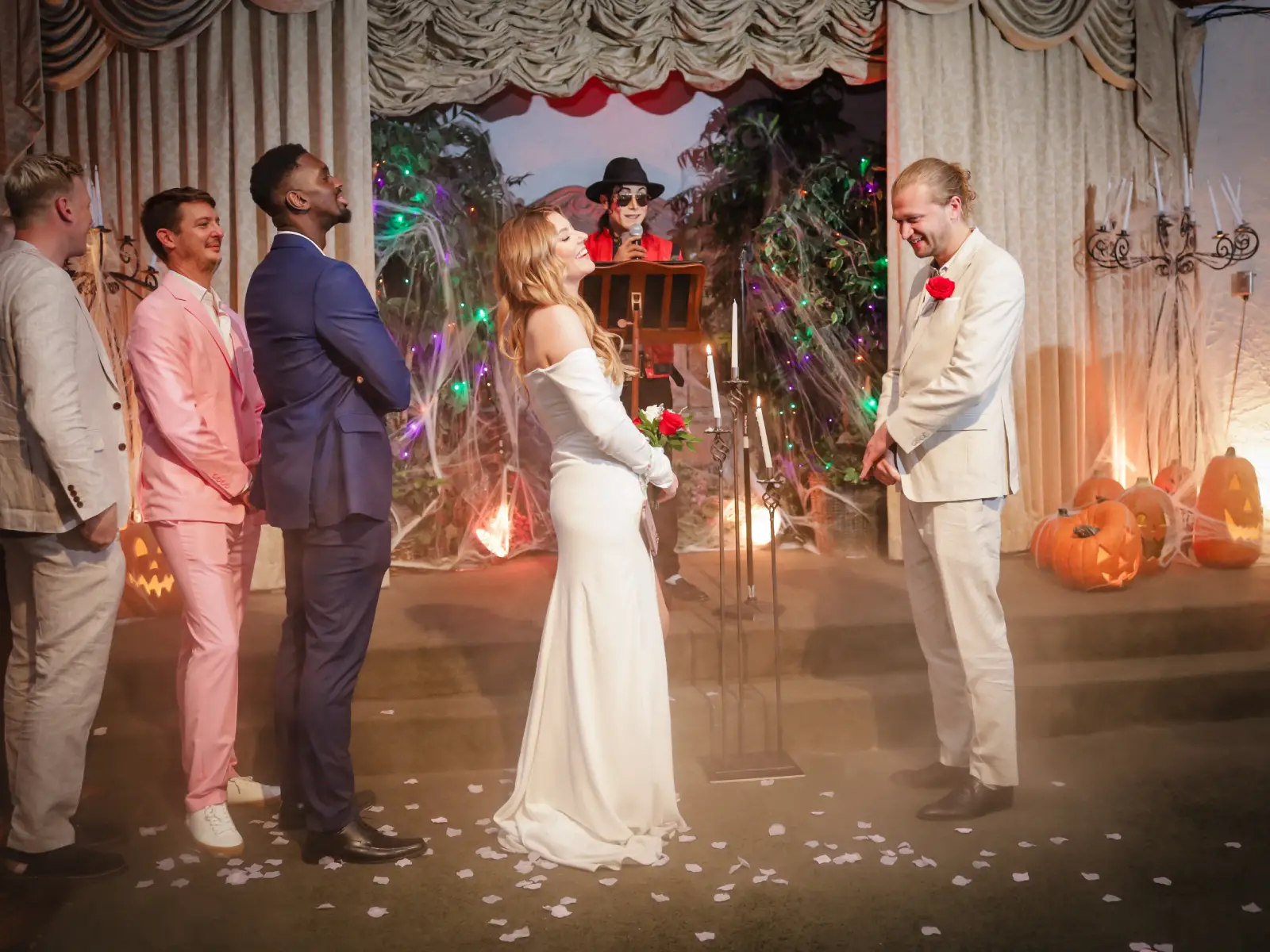 bride and groom standing at altar during themed wedding ceremony with halloween decorations