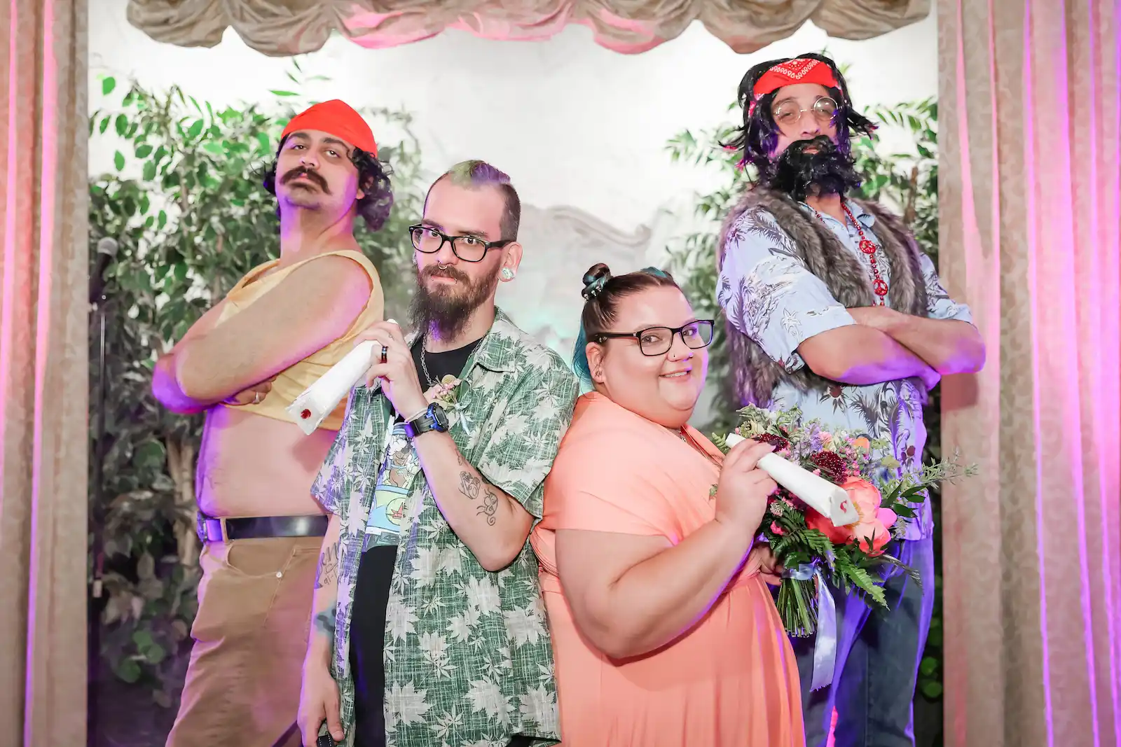 Newlyweds pose with Cheech and Chong impersonators holding wedding certificates at Las Vegas chapel