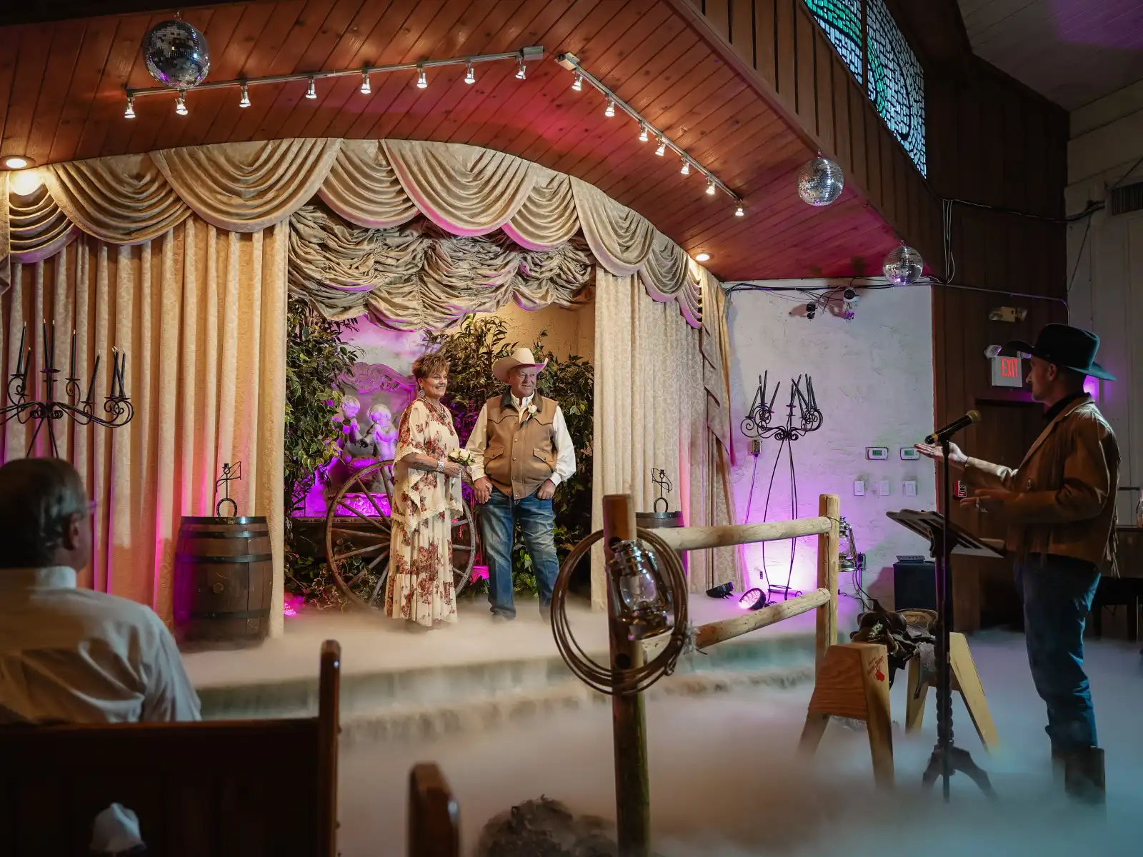 Couple at Las Vegas Western wedding ceremony with smoke.