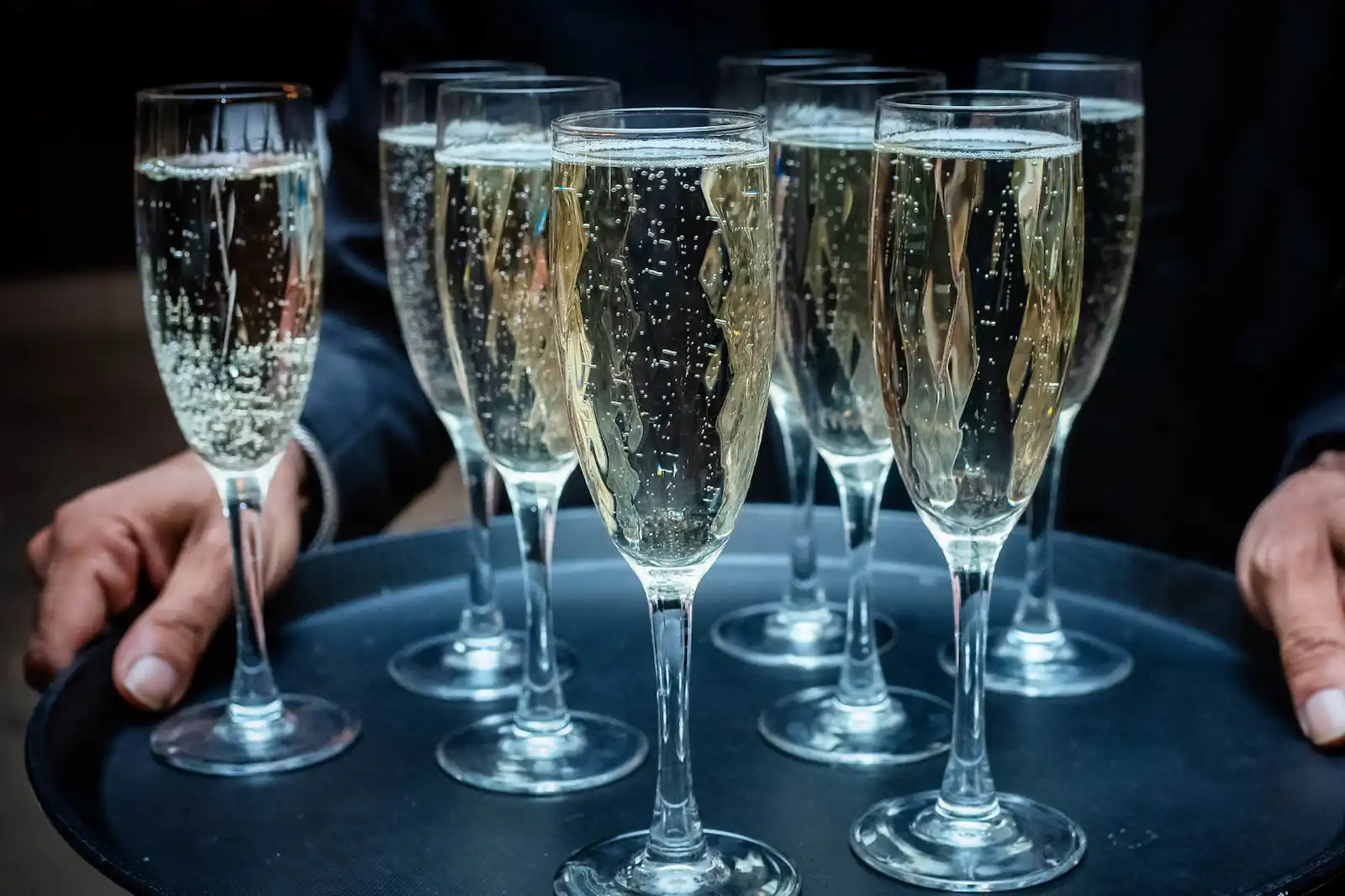 Tray of champagne flutes served during a wedding reception toast
