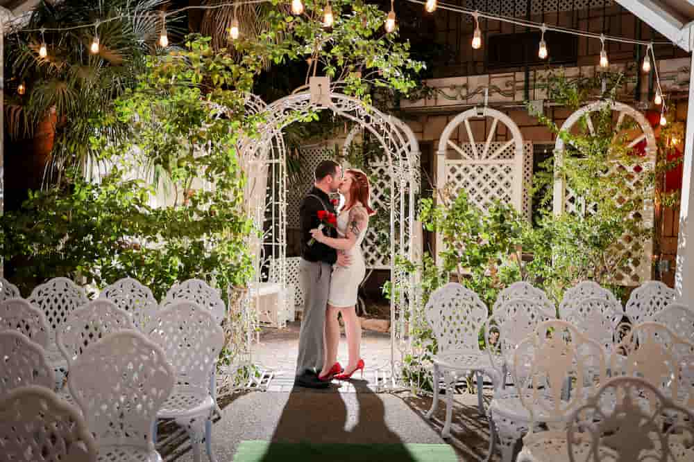 Couple sharing a kiss at the Bell Garden venue in Vegas on their wedding day