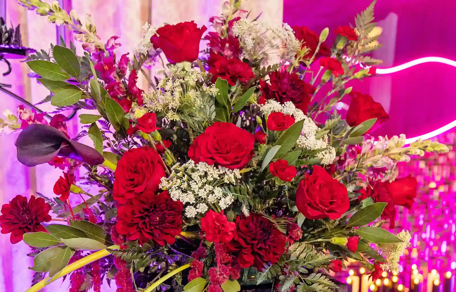 Gothic wedding altar floral spray with red roses, dahlias and dark calla lilies at Viva Las Vegas Weddings chapel