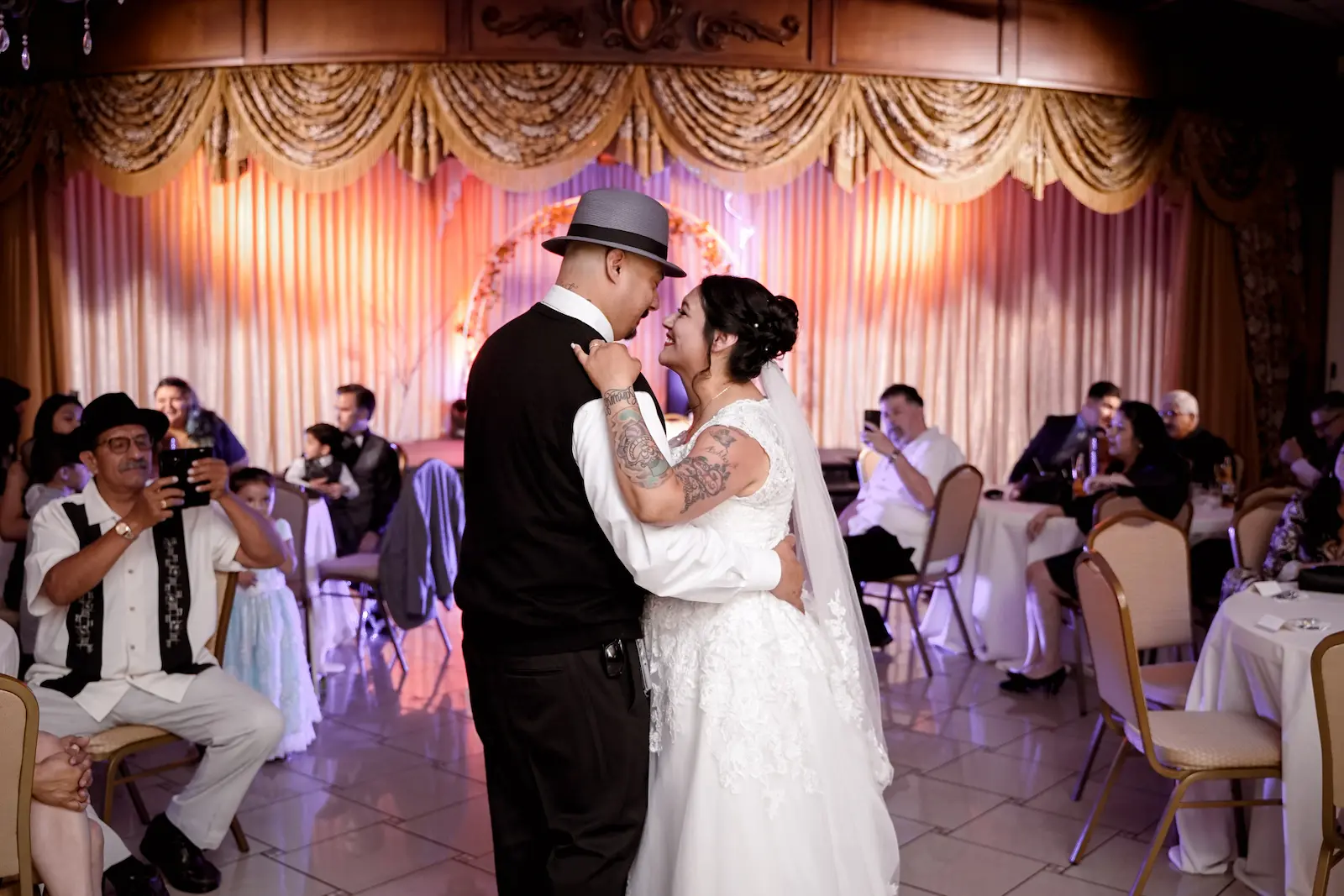 Bride and groom sharing their first dance with guests watching at the Viva Las Vegas Event Center reception