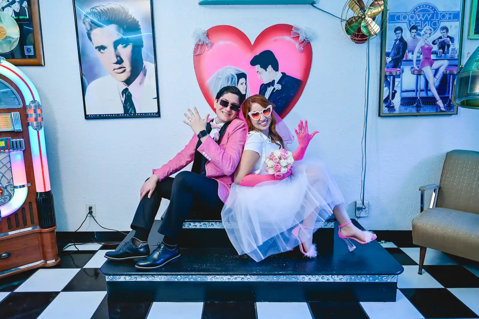 Couple posing playfully on vintage diner stage with Elvis themed decor Las Vegas