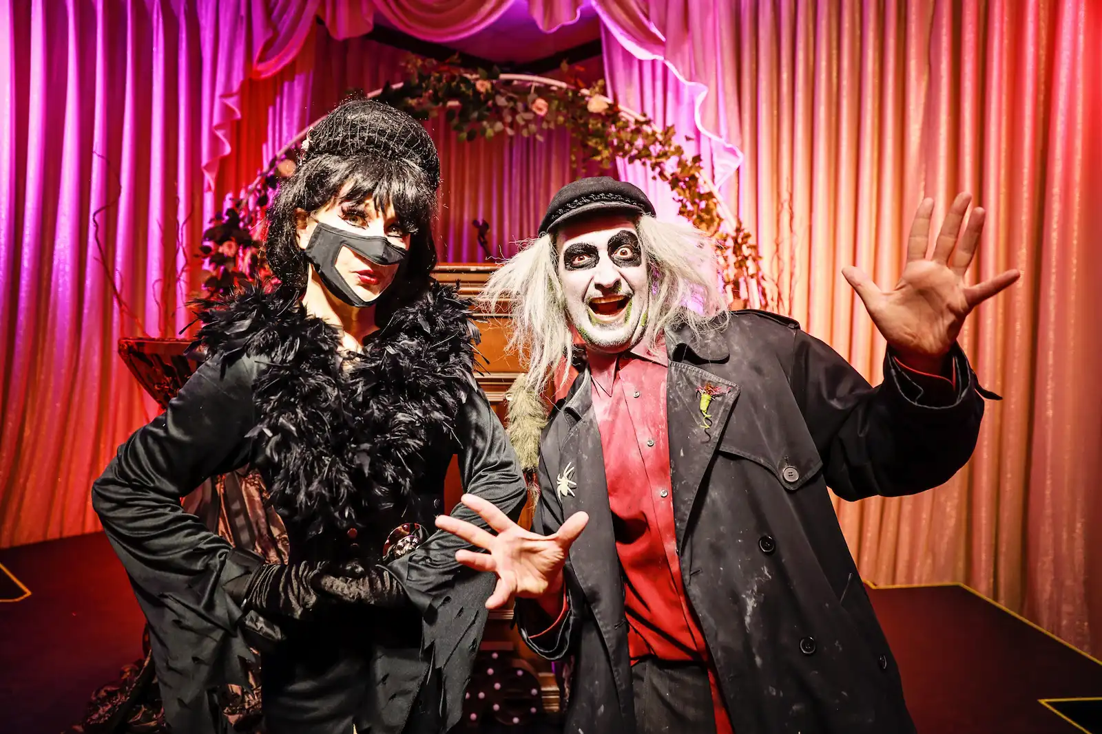 Elvira and Beetlejuice impersonators posing at a gothic Las Vegas wedding chapel