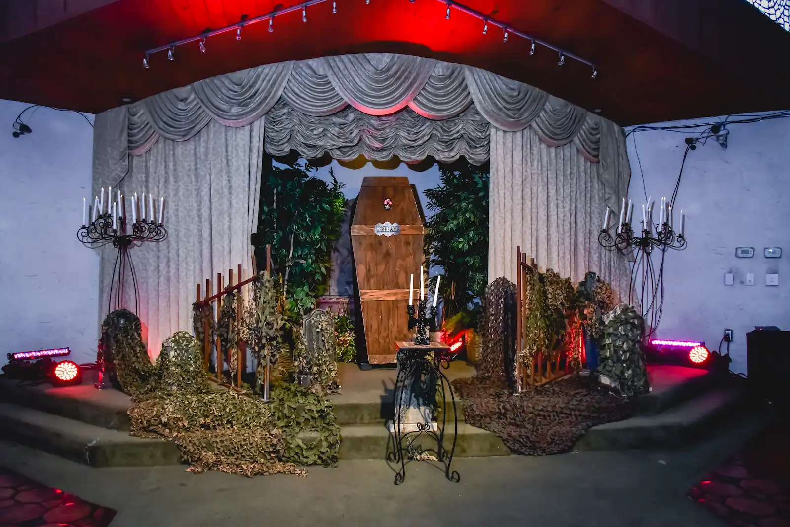 Gothic Halloween wedding ceremony stage with coffin centerpiece and candelabras at Viva Las Vegas Wedding Chapel