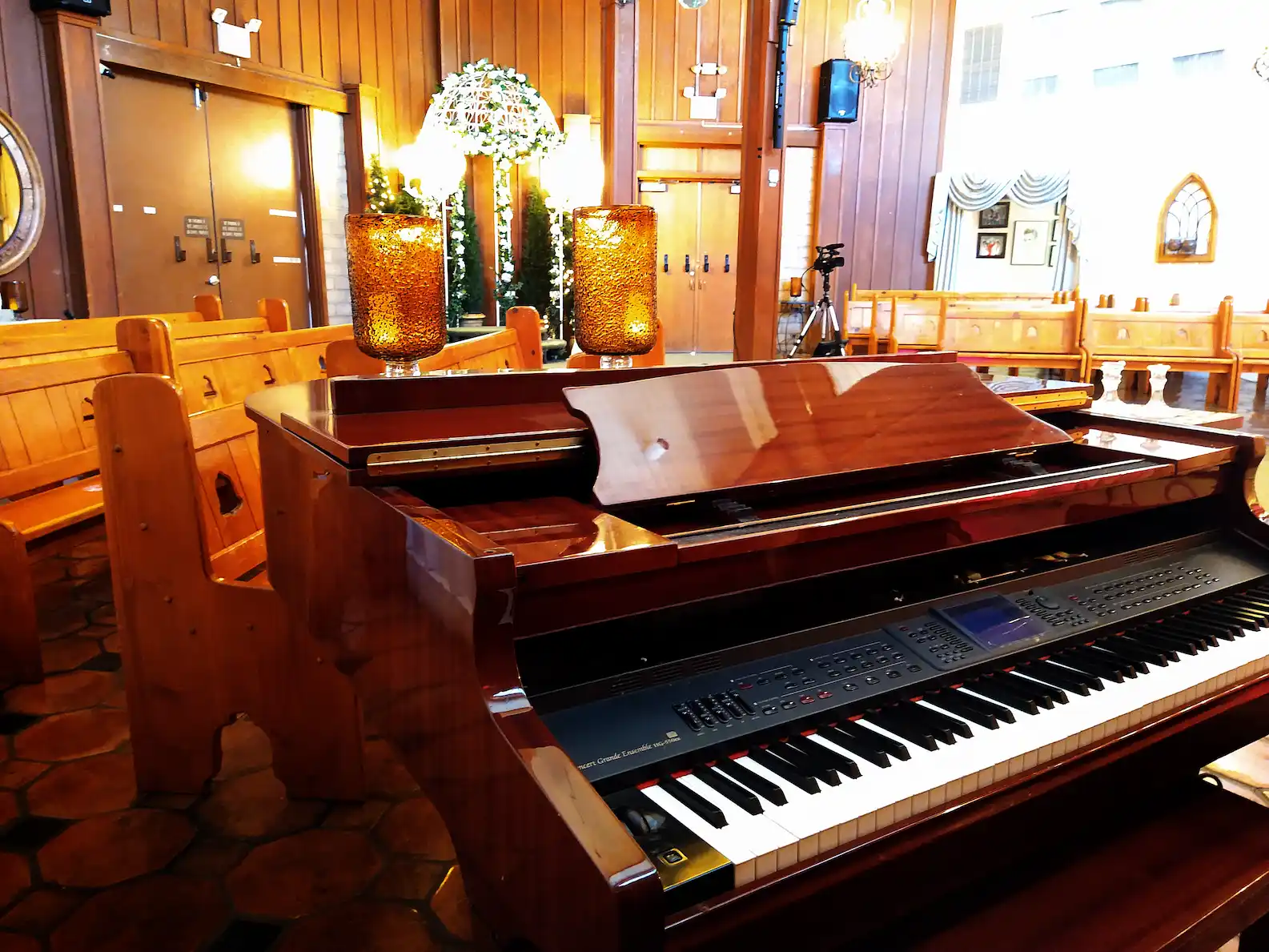 Grand piano inside Viva Las Vegas Wedding Chapel with wooden pews and warm lighting